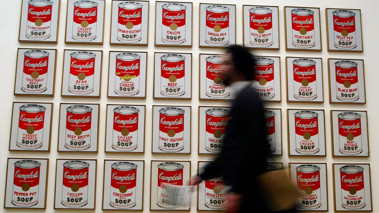 Campbell's Soup Company logo and cans on supermarket shelf
