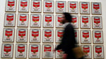 Campbell's Soup Company logo and cans on supermarket shelf