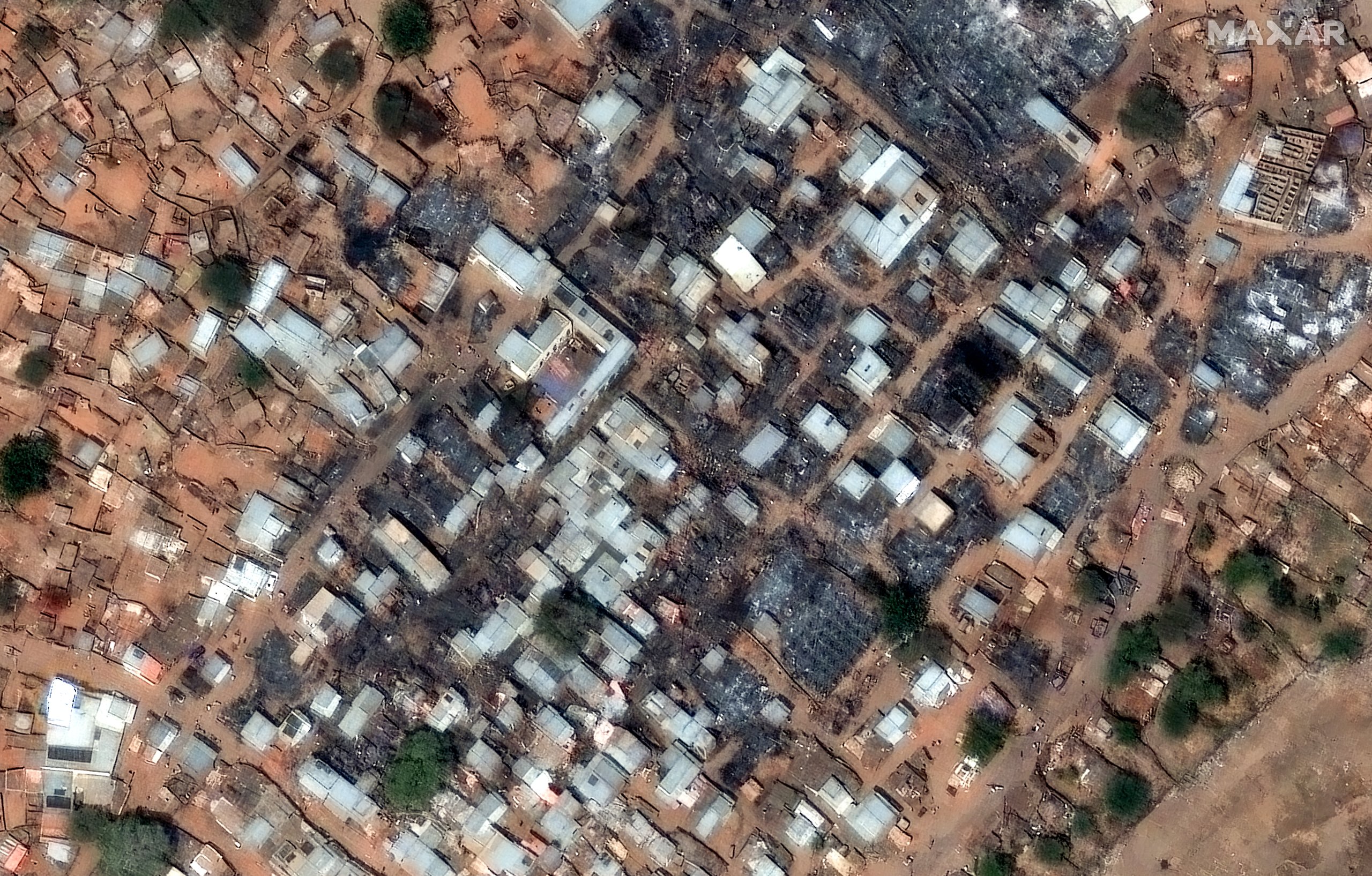 Aerial view of destroyed buildings and displaced people in El Fasher, Sudan conflict 2025