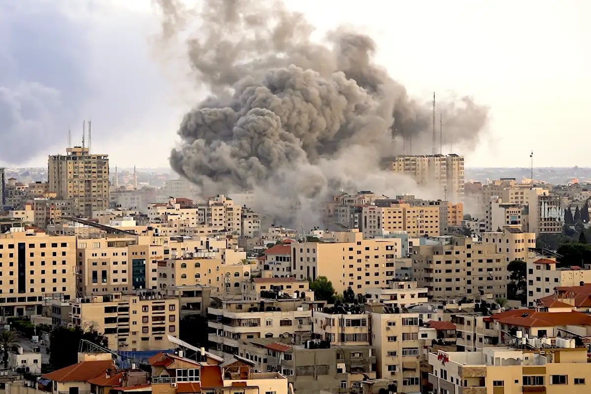 Gaza skyline showing severe damage and smoke from ongoing conflict in 2025