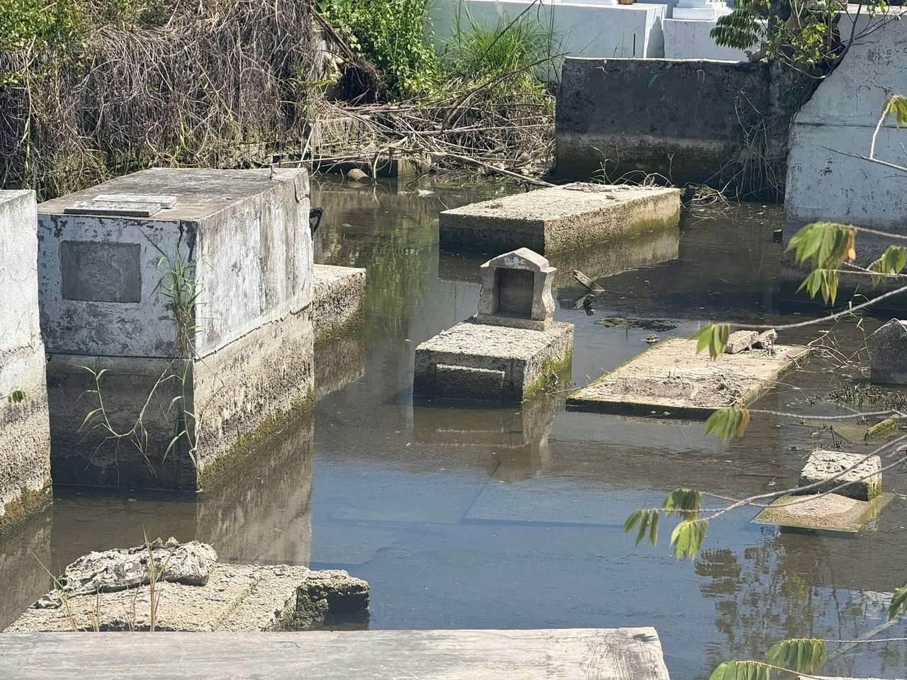 Ghost Project - Incomplete Flood Control Infrastructure Abandoned and incomplete flood control project showing exposed metal reinforcements and unfinished construction next to river, representing government corruption and ghost projects in the Philippines