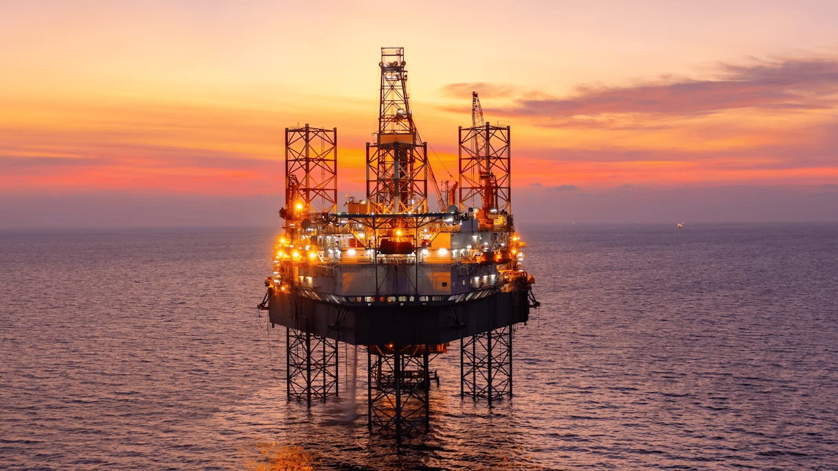 Oil refinery industrial plant at sunset representing IEA fossil fuel demand forecast until 2050