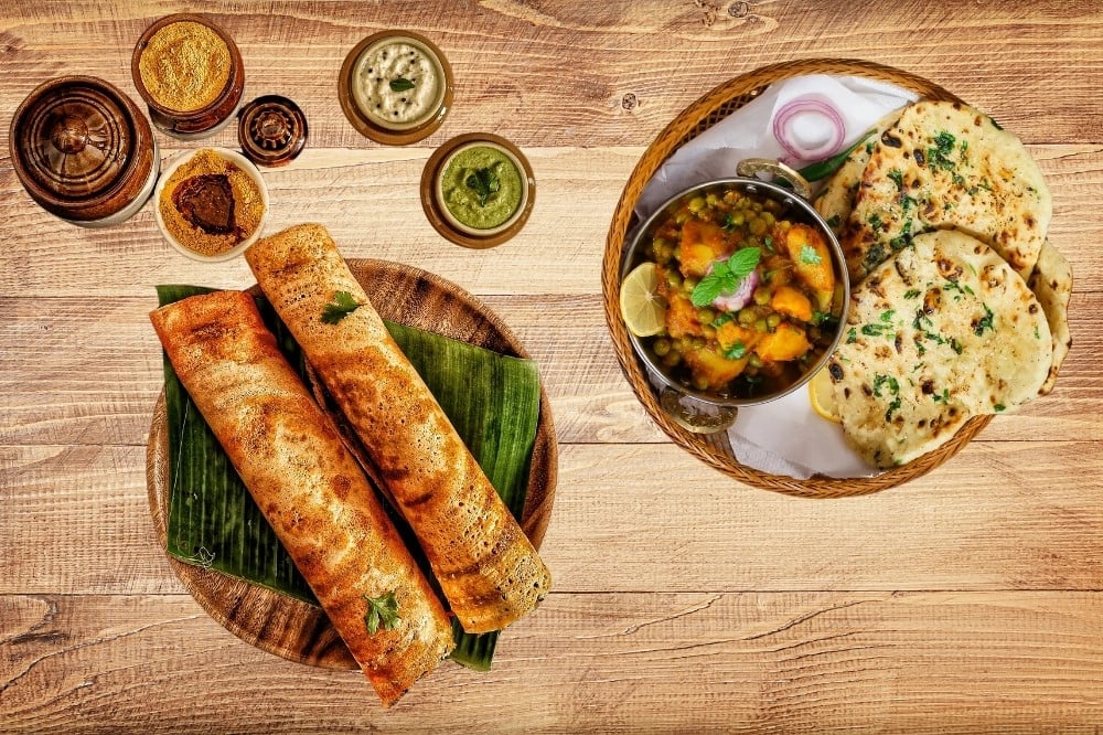 North vs South Indian Cuisine Traditional North Indian and South Indian dishes side by side