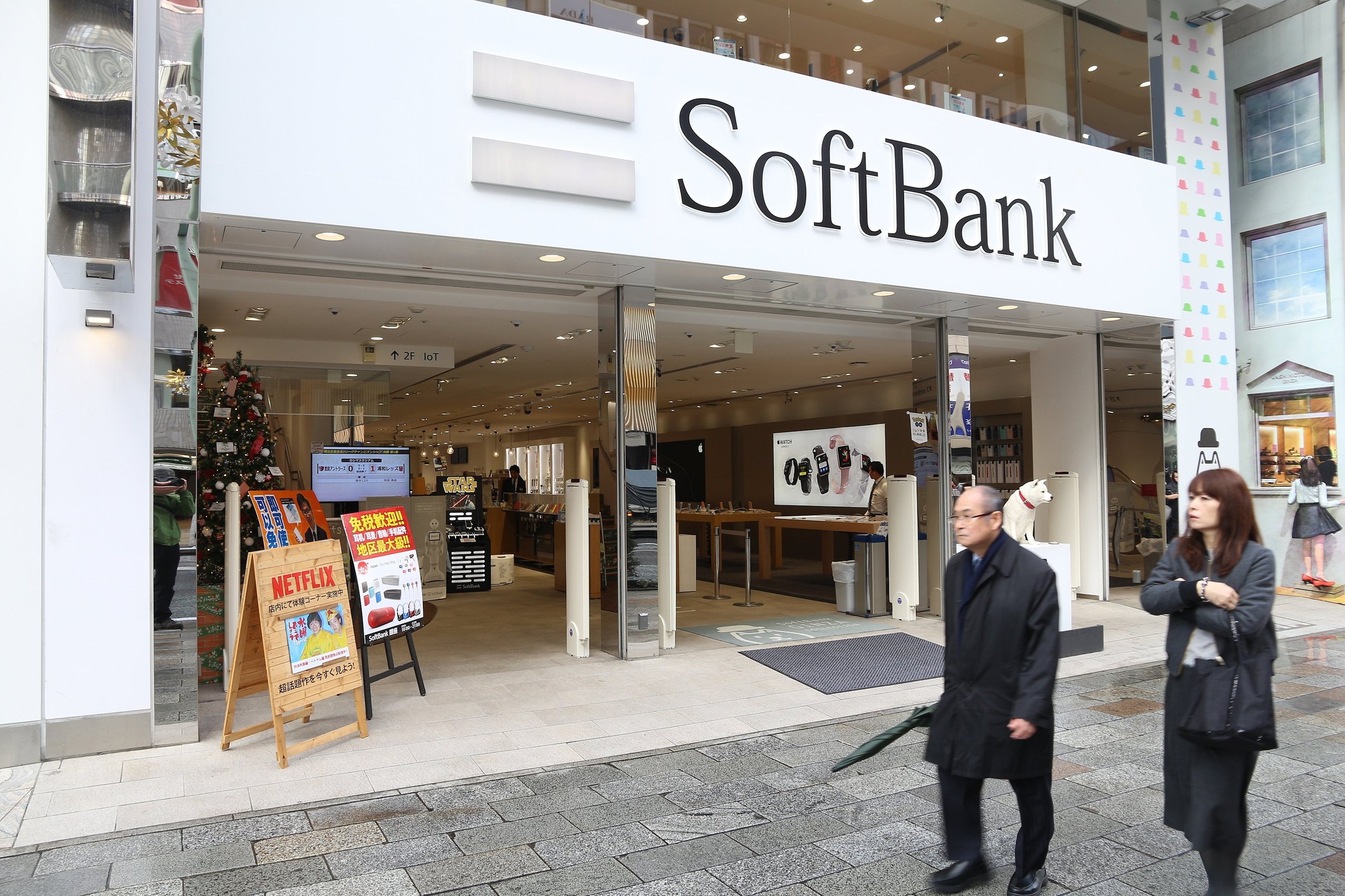 SoftBank building with downward trending stock arrows