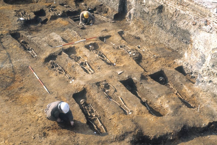 A mass grave in Sudan with UN peacekeepers surveying the site