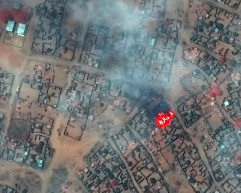 Aerial view of overcrowded displacement camp in Sudan showing thousands of makeshift shelters amid famine conditions during civil war