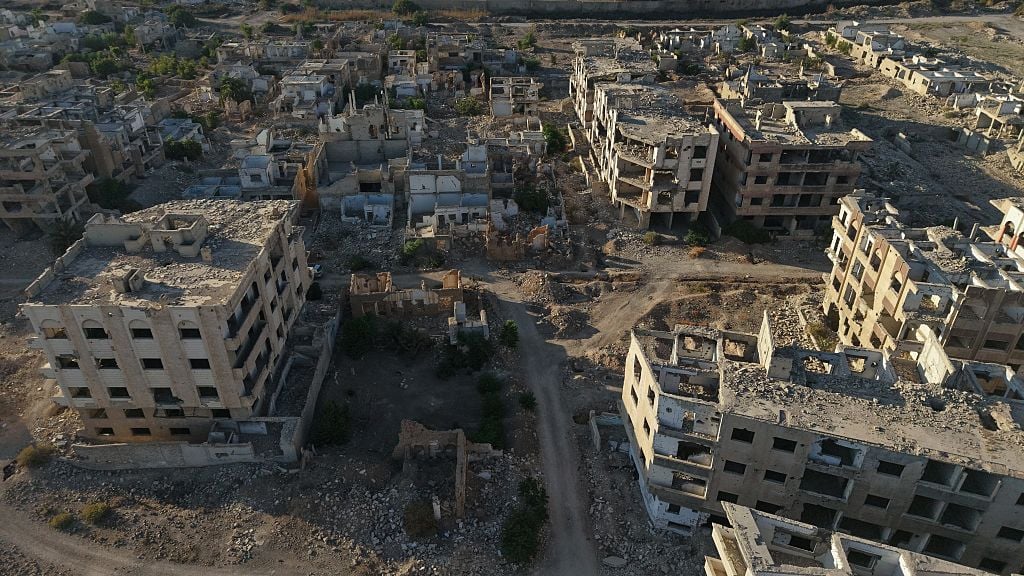 Syria reconstruction efforts and humanitarian crisis aftermath of civil war showing damaged infrastructure Damascus 2025