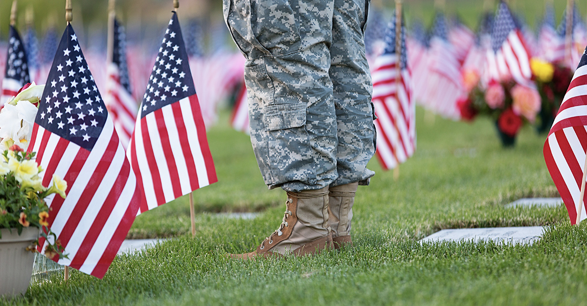 American flag waving on Veterans Day 2025 in Minnesota with memorial wreath honoring military service members