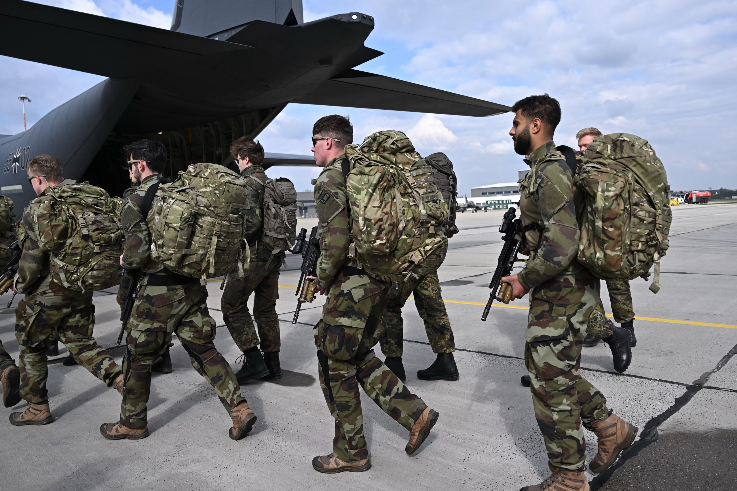 NATO military forces conducting joint defense exercises in Eastern Europe as alliance members increase defense spending to 2% GDP target