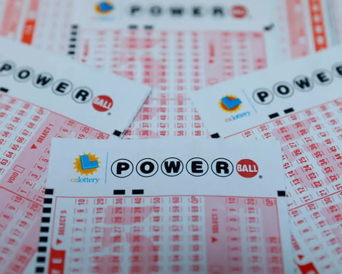 Powerball lottery ticket with $1.7 billion jackpot displayed alongside cash money for Christmas Eve 2024 drawing