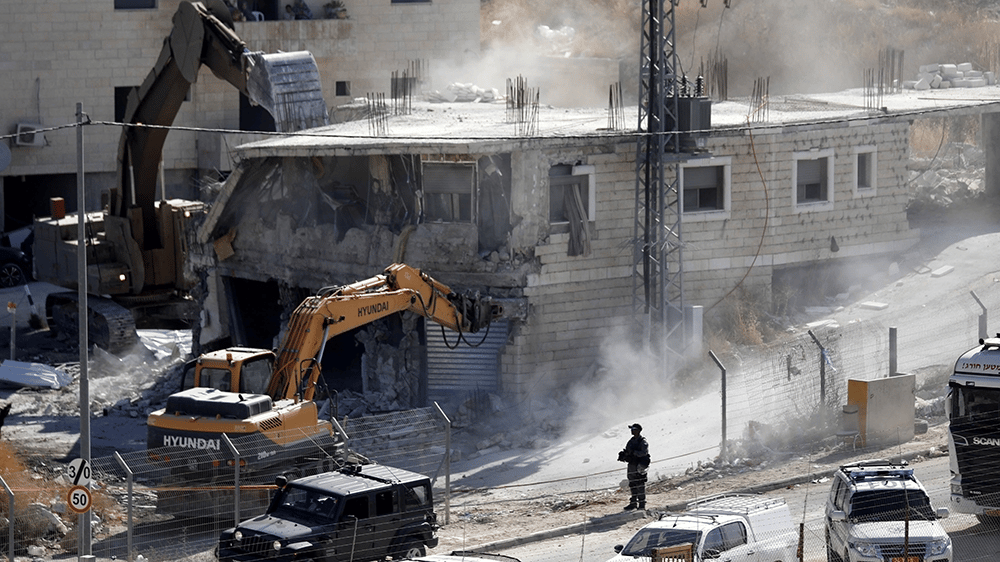 Destroyed residential buildings in Gaza City following Israeli airstrikes amid Western diplomatic support.
