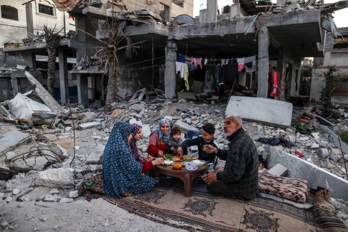 Palestinian family breaking fast in a destroyed home in Gaza during Ramadan