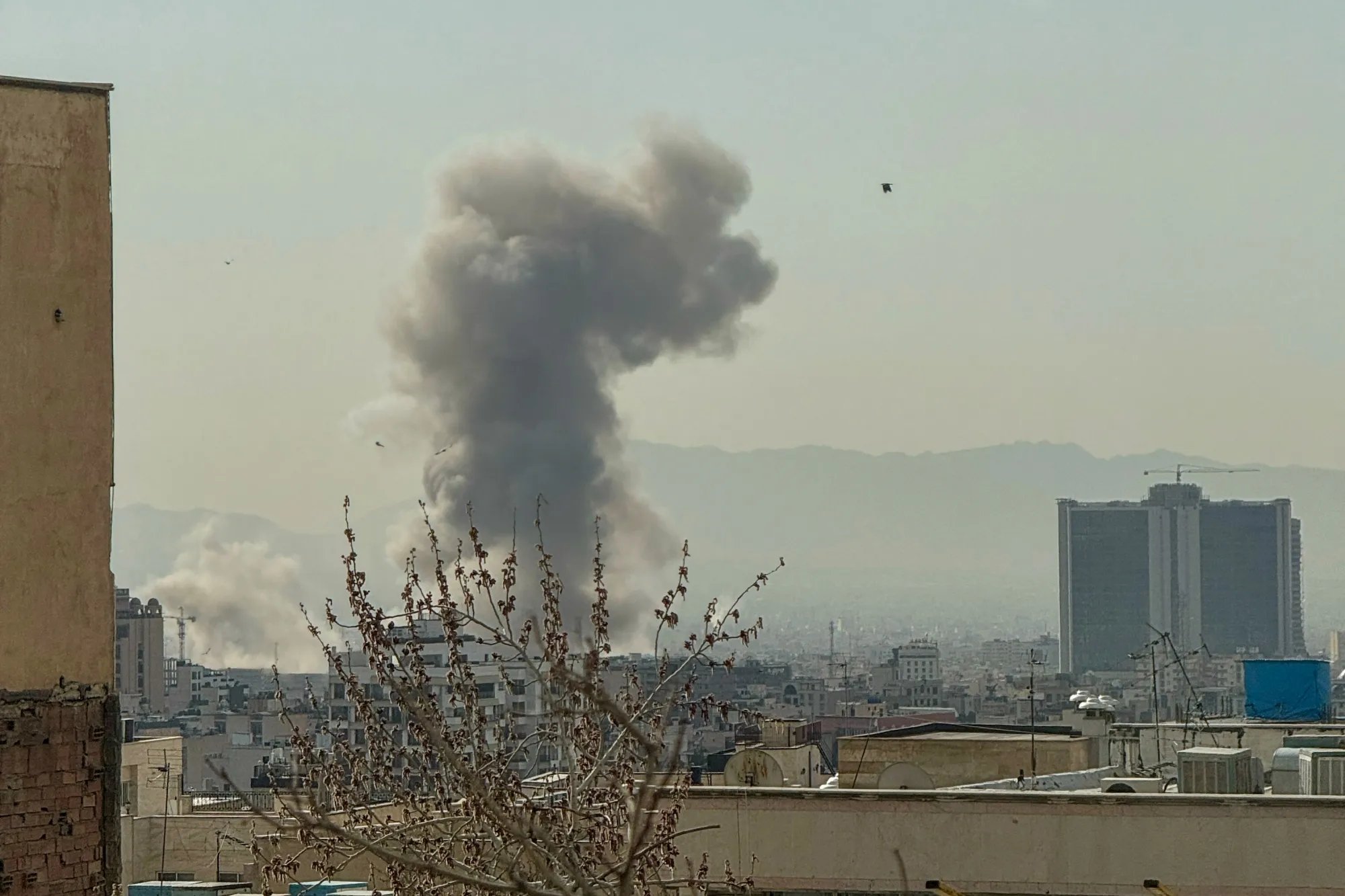 Smoke and destruction over Tehran after US-Israeli strikes on Iranian leadership in 2026