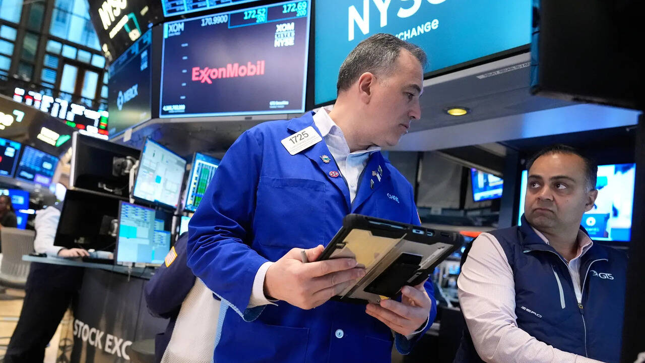 Traders react as US stock markets surge after oil price drop