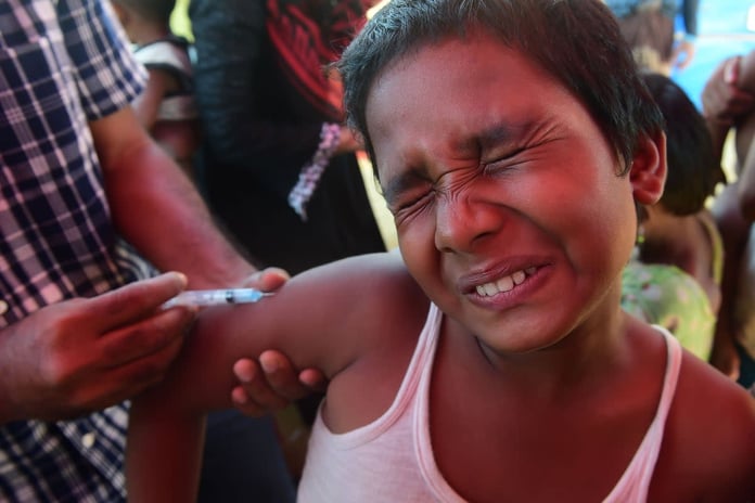 Children receiving measles vaccines during deadly outbreak in Bangladesh