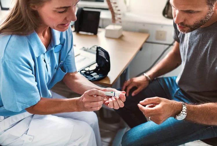 Clinical interpretation of CGM data doctor reviewing continuous glucose monitor data with patient in clinic