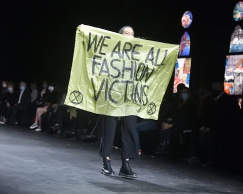 Activists protest on runway highlighting fashion industry sustainability crisis