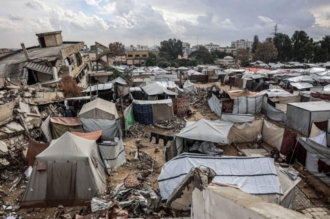 Displaced Palestinians living in tents in Gaza amid destruction