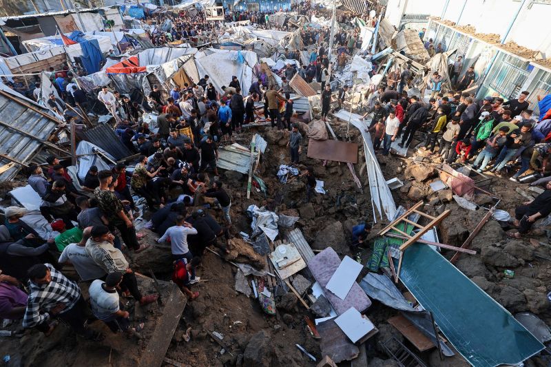 Civilians gather near damaged school shelter in Gaza after Israeli airstrike Civilians gather near damaged school shelter in Gaza after Israeli airstrike