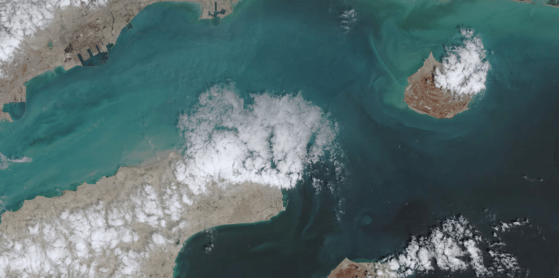 Satellite view of Strait of Hormuz showing tanker congestion during Israel attacks Iran war and US naval blockade