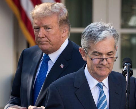 Federal Reserve Chair Jerome Powell speaks at a podium with a stern expression as he discusses the DOJ investigation into his leadership.