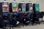 Players using slot machines inside a US casino environment
