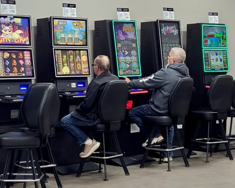 Players using slot machines inside a US casino environment