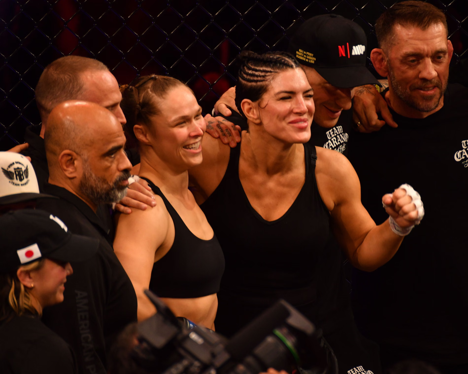 Gina Carano trapped in armbar submission by Ronda Rousey inside MMA cage