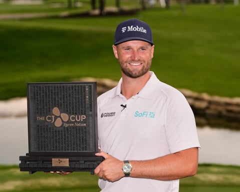 Wyndham Clark celebrates with the CJ Cup Byron Nelson trophy after shooting 60 at TPC Craig Ranch