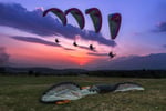 Paragliders flying over Bir Billing with Dhauladhar mountains in Himachal Pradesh