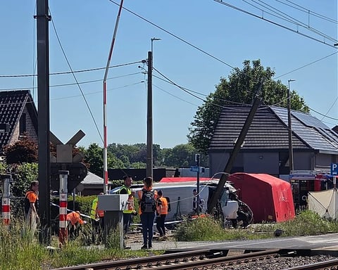 Rescue workers at the scene of a crash between a train and a school minibus at the Vierhuizen level crossing in Buggenhout, Belgium