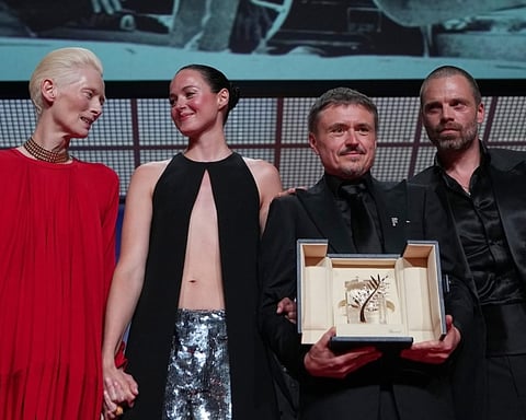 Tilda Swinton, Renate Reinsve, Cristian Mungiu and Sebastian Stan pose on stage during the Palme d'Or presentation at Cannes 2026