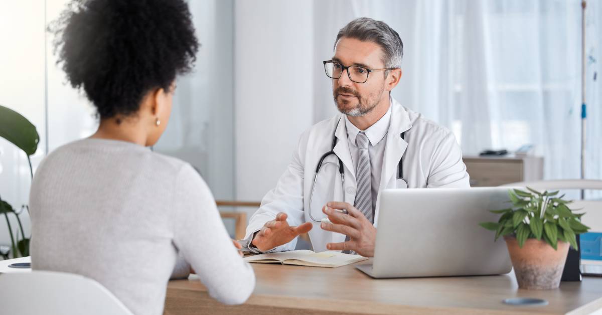 Doctor consulting a patient about headache symptoms and diagnosis