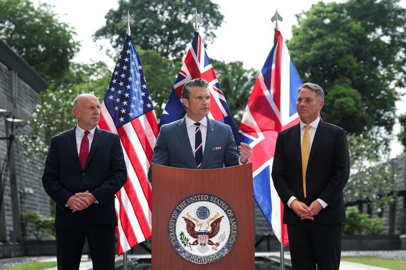US Secretary of Defense Pete Hegseth speaks alongside UK Defence Secretary John Healey and Australian Defence Minister Richard Marles at AUKUS press conference Singapore