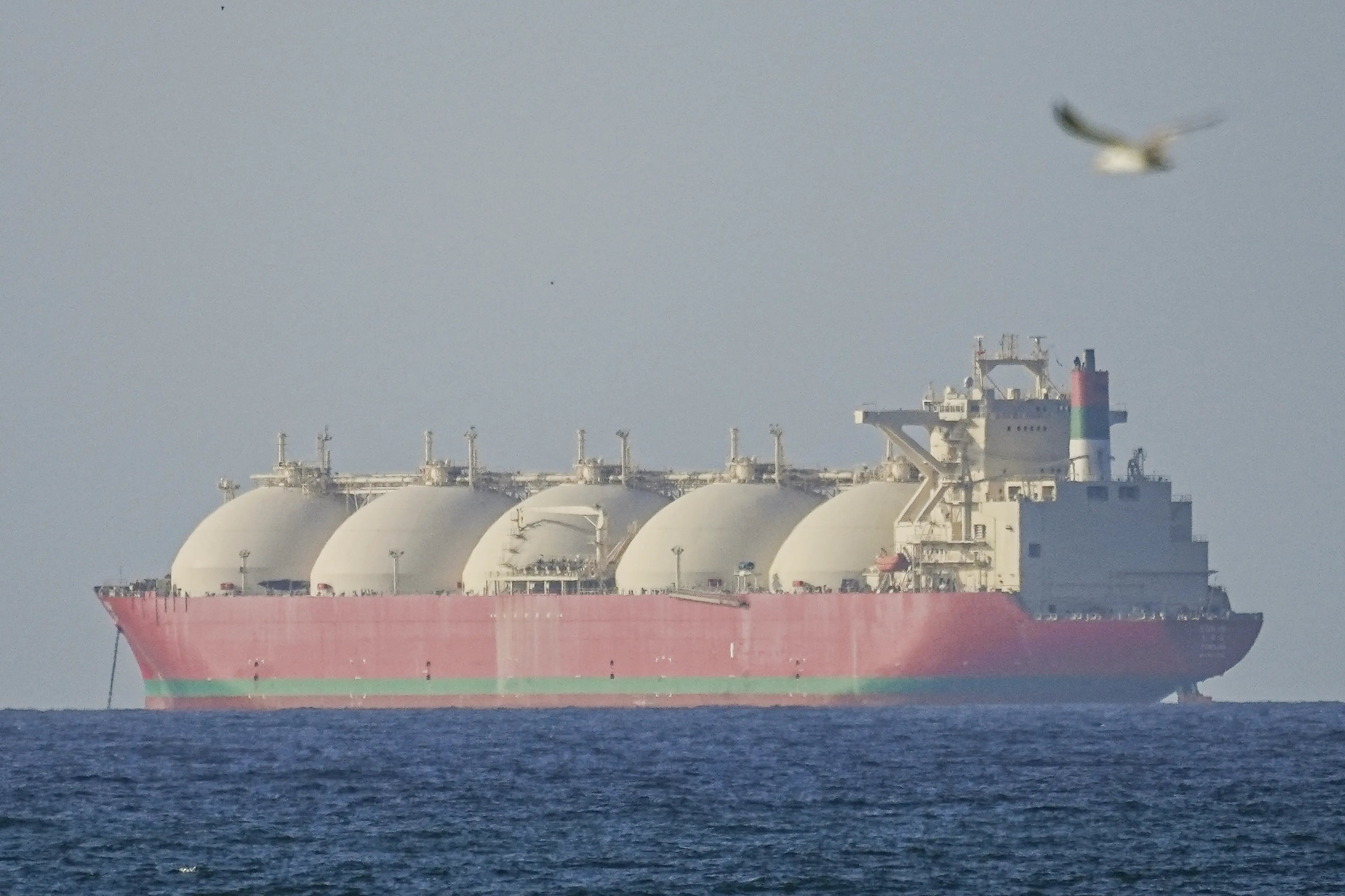 Iranian naval patrol boats operating near oil tankers in the Strait of Hormuz