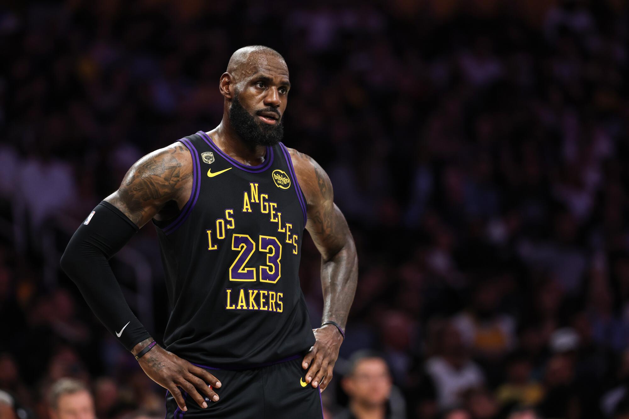 LeBron James in Los Angeles Lakers jersey during NBA playoff game with uncertain expression about retirement decision