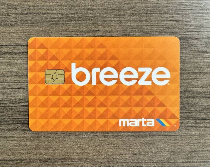 Commuter using Apple Wallet on iPhone to access a MARTA station in Atlanta