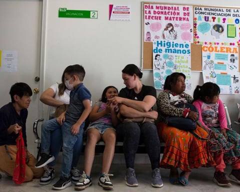 Health worker administering MMR measles vaccine to child in Cuauhtemoc Mexico amid 2026 outbreak