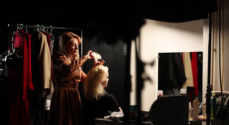 Assistants adjusting elaborate Met Gala gown backstage highlighting fashion logistics and labor