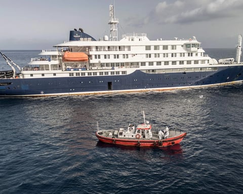 Medical teams in protective suits board MV Hondius during hantavirus outbreak investigation