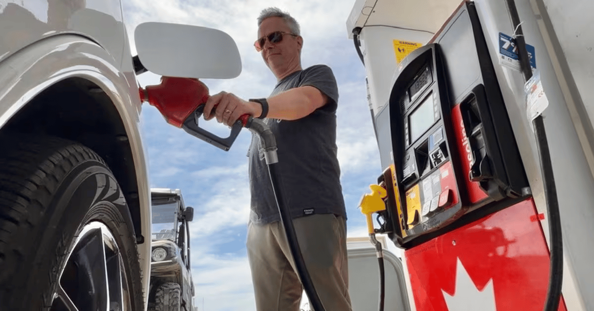 Drivers fill vehicles at a gas station in Newfoundland after fuel prices dropped ahead of the Victoria Day weekend
