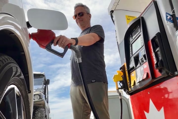 Drivers fill vehicles at a gas station in Newfoundland after fuel prices dropped ahead of the Victoria Day weekend