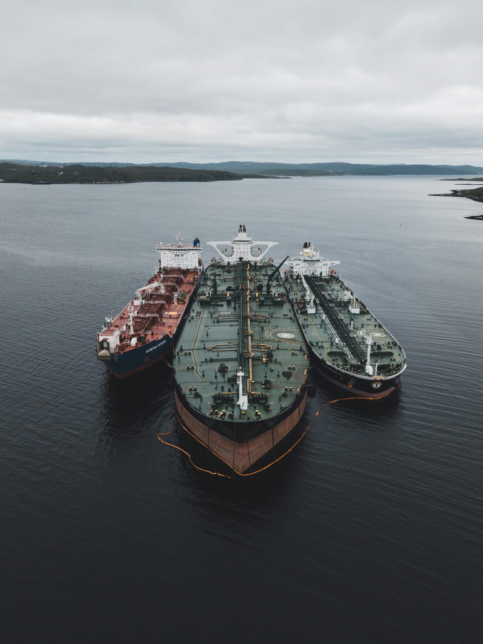 Oil tankers anchored under cloudy skies as the United States and Iran approach a framework agreement to reopen the Strait of Hormuz