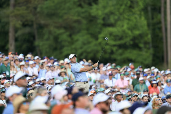 PGA Tour event crowd and leaderboard action Crowd watching PGA Tour golf event with leaderboard showing competition standings