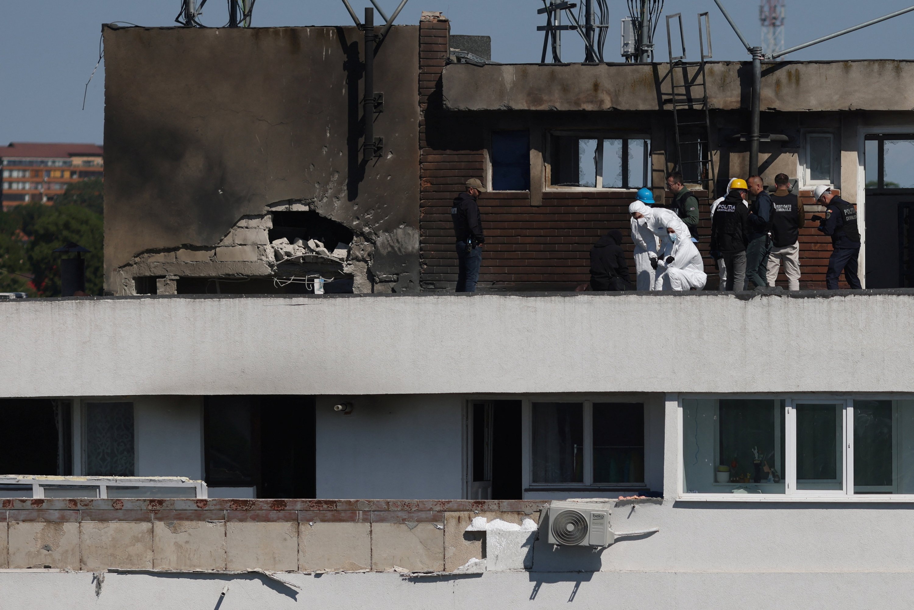 Romanian law enforcement officers at the Galati apartment block hit by a Russian drone