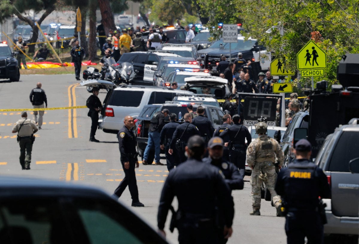 Police and emergency crews secure the Islamic Center of San Diego after two terrorists invoking a Christian crusade killed three in Clairemont