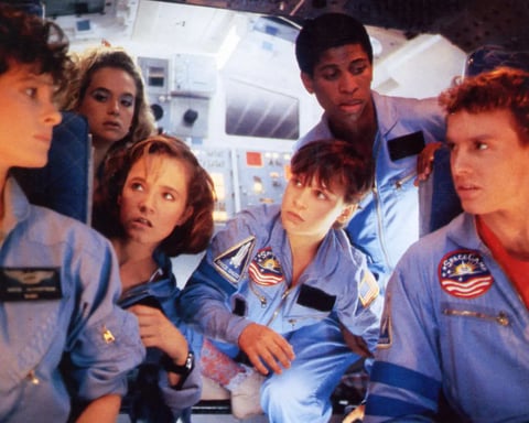 SpaceCamp 1986 film theatrical poster featuring Lea Thompson Joaquin Phoenix and cast in NASA jumpsuits