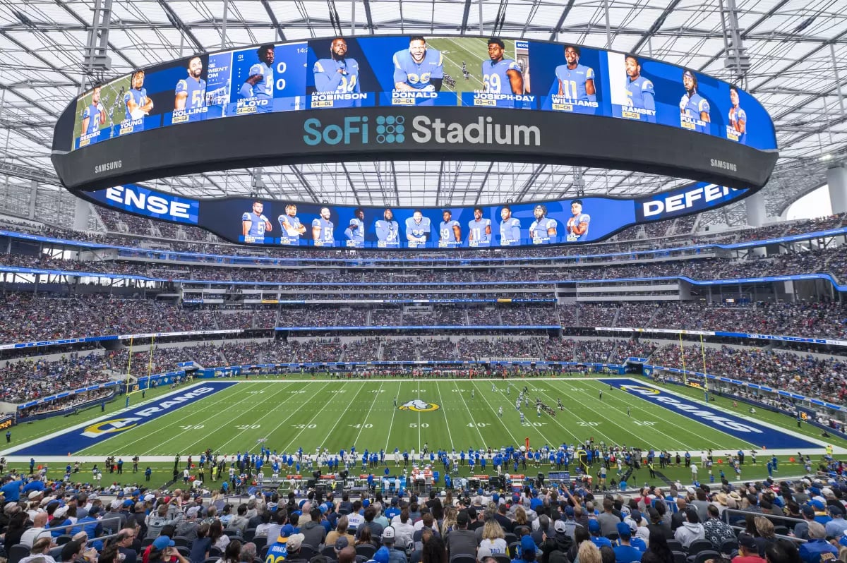 Packed stadium during Super Bowl with global audience and lights