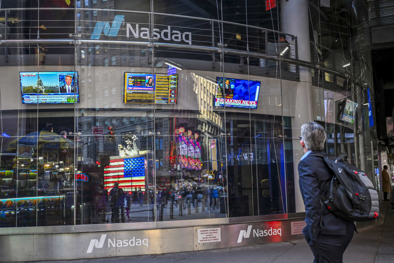 Donald Trump displayed on screens at the New York Stock Exchange during controversy over massive stock trade disclosures