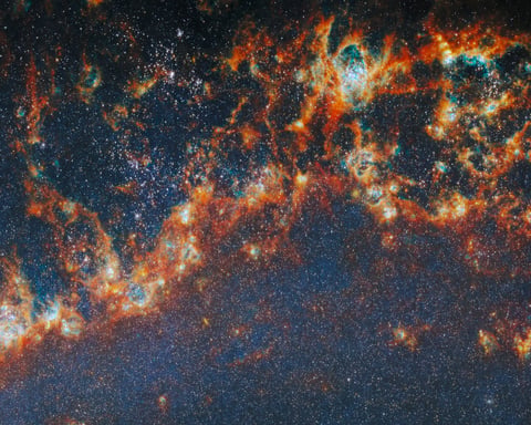 Webb Telescope near-infrared image showing Messier 51 spiral arm with young star clusters lighting bubbles inside dense gas